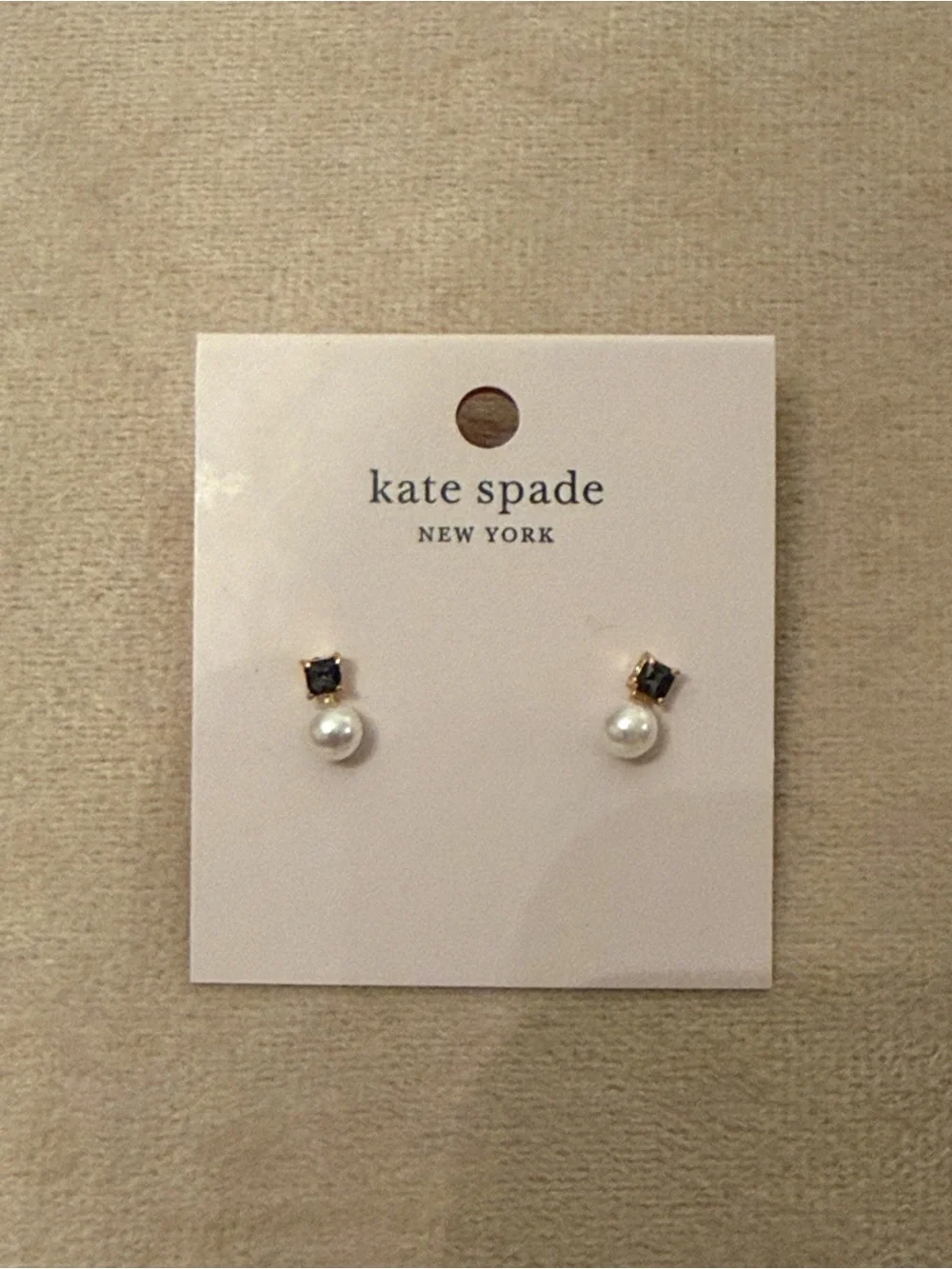 kate spade gold-tone stud earrings with clear backs on pink card